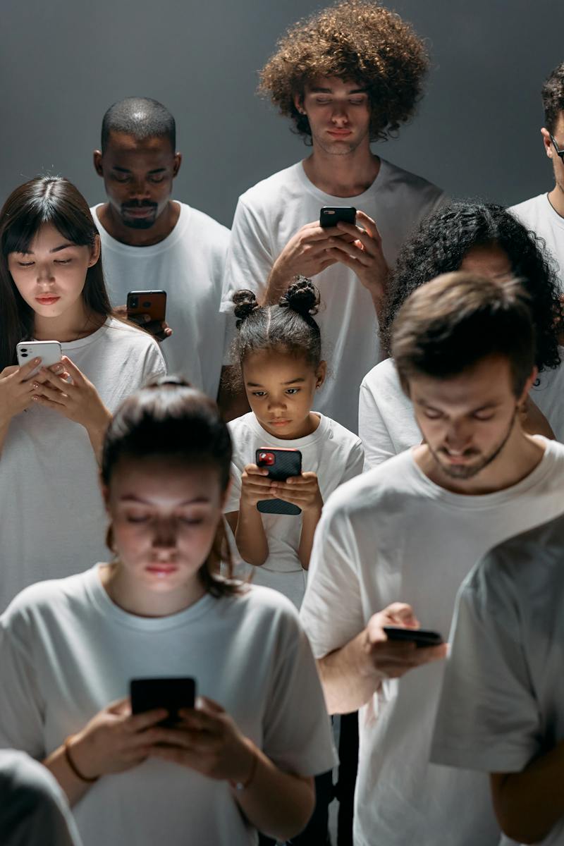 Photo of People Engaged on their Phones